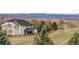 Beautifully landscaped property with lush green lawns and mountain views in the background at 1348 Lawson Ave, Erie, CO 80516