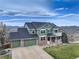 Green two story home with three-car garage, and mountain views at 1348 Lawson Ave, Erie, CO 80516