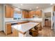 Eat-in kitchen with stainless steel appliances, an island, and hardwood floors at 1348 Lawson Ave, Erie, CO 80516