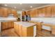 Spacious kitchen featuring wood cabinets, large island, stainless steel appliances, and granite countertops at 1348 Lawson Ave, Erie, CO 80516