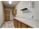 Laundry room featuring a utility sink, laminate countertops, and tile floor at 1348 Lawson Ave, Erie, CO 80516
