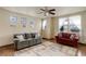 Cozy living room featuring large windows, comfortable seating, and stylish decor at 1348 Lawson Ave, Erie, CO 80516