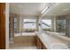 Main bathroom featuring dual sinks, a jetted tub, separate glass shower, and tile flooring at 1348 Lawson Ave, Erie, CO 80516