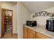 Walk-in pantry with wood cabinets and countertops, next to open pantry with small microwave at 1348 Lawson Ave, Erie, CO 80516