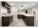 Basement bar with tile floor, under-counter refrigerators, and white tiled bar front at 3427 S Cherry St, Denver, CO 80222
