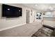 Finished basement with wall-mounted TV and neutral carpet at 3427 S Cherry St, Denver, CO 80222