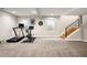 Finished basement gym with exercise equipment, stairs and windows at 3427 S Cherry St, Denver, CO 80222