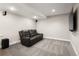 Finished basement with leather sofa and wall-mounted TV at 3427 S Cherry St, Denver, CO 80222