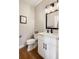 Bathroom with a modern vanity, marble countertop, and a decorative mirror at 3427 S Cherry St, Denver, CO 80222