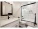 Bathroom with white vanity, tiled shower, and black hardware at 3427 S Cherry St, Denver, CO 80222