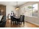 Dining room featuring modern decor, a large window, and hardwood floors in a bright space at 3427 S Cherry St, Denver, CO 80222