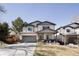 Charming two-story home with a well-manicured lawn, complemented by neutral siding and a paved driveway leading to an attached garage at 3427 S Cherry St, Denver, CO 80222