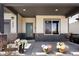 Inviting front porch featuring stone accents, a teal door, and beautiful floral arrangements at 3427 S Cherry St, Denver, CO 80222