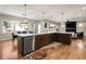 Bright kitchen with an oversized island, stainless steel appliances, and hardwood flooring throughout at 3427 S Cherry St, Denver, CO 80222