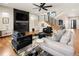 Another angle of the living room highlighting the modern staircase, stylish fireplace, and comfortable seating arrangement at 3427 S Cherry St, Denver, CO 80222