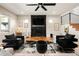An additional perspective of the living room showcasing modern decor, a statement fireplace, and an open floor plan at 3427 S Cherry St, Denver, CO 80222