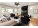 Comfortable living room featuring stylish furniture, a large black marble fireplace, and hardwood floors at 3427 S Cherry St, Denver, CO 80222
