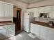 Functional kitchen with white cabinetry, and laminate countertops at 1646 Galena St, Aurora, CO 80010