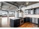 Modern kitchen with dark cabinetry, quartz countertops, and stainless steel appliances at 2000 Little Raven St # 703, Denver, CO 80202