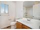 Bright bathroom showcasing a single sink vanity, ample lighting, and a shower-tub combo at 4697 Waldenwood Dr, Highlands Ranch, CO 80130