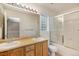 Bright bathroom boasts a dual-sink vanity and a glass-enclosed shower at 4697 Waldenwood Dr, Highlands Ranch, CO 80130