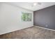 Comfortable bedroom features a large window, two-toned wall, and wall-to-wall carpet flooring at 4697 Waldenwood Dr, Highlands Ranch, CO 80130