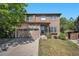 Charming two-story home featuring stone accents, a well-manicured lawn, and attached two car garage at 4697 Waldenwood Dr, Highlands Ranch, CO 80130