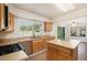 Well-lit kitchen with stainless steel appliances, wood cabinets, and an island providing ample counter space at 4697 Waldenwood Dr, Highlands Ranch, CO 80130