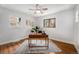 Bedroom featuring hardwood flooring, neutral walls, and multiple windows at 1865 S Logan St, Denver, CO 80210