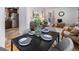 Open-concept dining area showcasing hardwood floors and seamless flow to the kitchen and living spaces at 1865 S Logan St, Denver, CO 80210