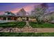 Inviting brick home with a well-manicured lawn, sidewalk and flowering tree at 1865 S Logan St, Denver, CO 80210