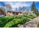 Beautiful single Gathering home boasts a lush green lawn with a sidewalk leading up to the front door at 1865 S Logan St, Denver, CO 80210