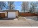 Detached one-car garage with white door and brick siding at 1865 S Logan St, Denver, CO 80210