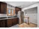 The kitchen features dark wood cabinets, granite countertops, and stainless steel appliances at 1865 S Logan St, Denver, CO 80210