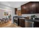 Modern kitchen featuring stainless steel appliances, dark wood cabinets and granite countertops at 1865 S Logan St, Denver, CO 80210