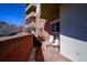 View of a condo balcony featuring a red brick surround and outdoor seating at 4875 S Monaco St # 103, Denver, CO 80237