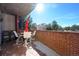 Relaxing condo balcony featuring a brick surround and outdoor seating and tables at 4875 S Monaco St # 103, Denver, CO 80237