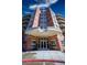 Elegant brick building entrance featuring modern doors and manicured planters for a welcoming arrival at 4875 S Monaco St # 103, Denver, CO 80237