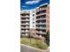 Exterior shot of a condominium complex with a red brick facade and multiple balconies at 4875 S Monaco St # 103, Denver, CO 80237