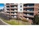 Exterior view of a condo building featuring multiple units with balconies at 4875 S Monaco St # 103, Denver, CO 80237