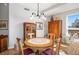 Charming dining room featuring a wooden table, decorative chandelier and antique furnishings at 4875 S Monaco St # 103, Denver, CO 80237