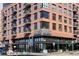 Exterior of brick commercial building with One7, Crisp & Green storefronts and outdoor seating at 4875 S Monaco St # 103, Denver, CO 80237