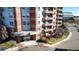 Attractive entrance of a brick apartment building with manicured landscaping at 4875 S Monaco St # 103, Denver, CO 80237