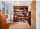 Well-appointed home office with custom wood shelving and built-in desk at 4875 S Monaco St # 103, Denver, CO 80237