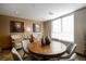 Cozy meeting room with round wooden table, comfortable seating, and natural light from a window at 4875 S Monaco St # 103, Denver, CO 80237