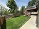 Spacious backyard with green grass, wood fence, and a two-story deck at 23760 Broadmoor Dr, Parker, CO 80138