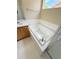 Bathroom featuring a tub with white tile surround, and a single sink vanity at 23760 Broadmoor Dr, Parker, CO 80138