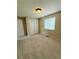 Bedroom featuring neutral walls, carpeting, closet with double doors and natural light at 23760 Broadmoor Dr, Parker, CO 80138