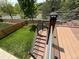Two-story deck with metal handrail overlooking backyard with green grass and wood fence at 23760 Broadmoor Dr, Parker, CO 80138