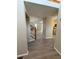 Neutral entryway featuring wood-style flooring, stairs, and access to kitchen at 23760 Broadmoor Dr, Parker, CO 80138